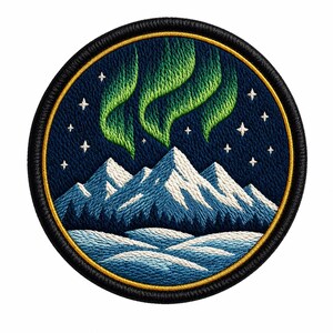 May include: A circular embroidered patch featuring a night sky with bright green aurora borealis and white stars above snow-capped blue mountains and a dark forest. The design is framed by a thin gold border and a thick black stitched edge.
