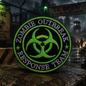 May include: A circular embroidered patch featuring a bright green biohazard symbol centered on a black background. The text ZOMBIE OUTBREAK RESPONSE TEAM is stitched in white around the border, accented by two small green stars on the sides.