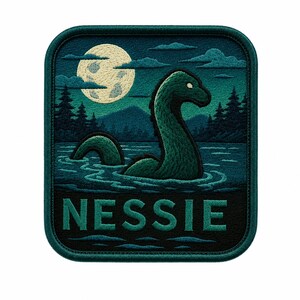 May include: A square embroidered patch featuring a dark green lake scene with a long-necked creature emerging from the water. A large pale moon hangs in the sky above silhouetted pine trees and mountains. The word NESSIE is stitched in teal.