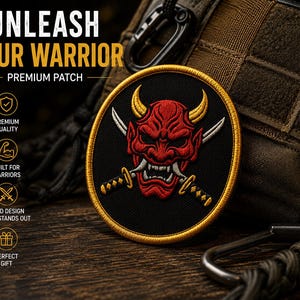 May include: A circular embroidered patch featuring a red Japanese-style demon mask with yellow horns and white fangs, centered over two crossed silver swords with black and gold hilts, all enclosed by a thick gold border on a black background.
