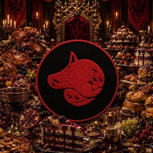 May include: A circular black patch featuring a textured red embroidered design of a stylized pig head in profile. The patch has a red stitched border and is centered against a dark, ornate background filled with a feast of food and drink.