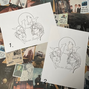 May include: Two black and white line drawings of a couple with wolves and a full moon. The text "You were Beautiful" is written below each drawing. The drawings are numbered 1 and 2.