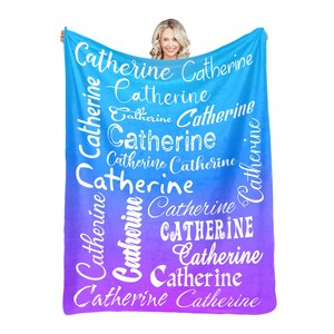 May include: A blue and purple ombre fleece blanket with the name "Catherine" repeated in white text in various sizes and styles.