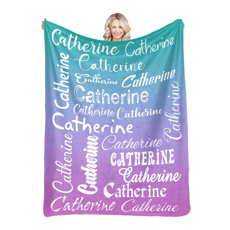 May include: A soft, plush blanket with a gradient of teal and purple colors. The blanket features the name "Catherine" repeated in a white, stylized font.