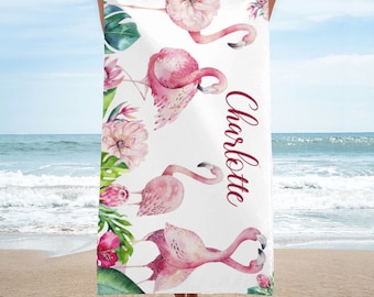 May include: Pink flamingo beach towel with a white background and green leaves. The towel has the name "Charlotte" written in maroon cursive.
