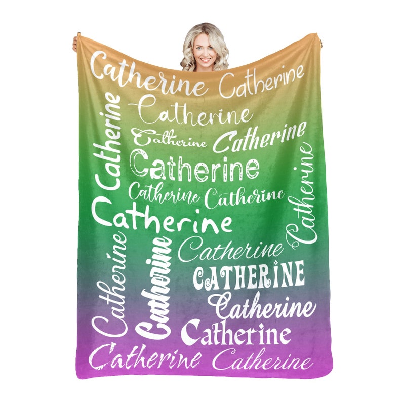 May include: A soft, colorful fleece blanket with the name "Catherine" repeated in white lettering on a gradient background of yellow, green, and purple.