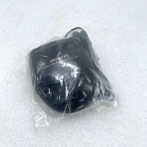 May include: A black Aiwa remote control extender HT-M301, packaged in a clear plastic bag. The text "aiwa" is visible in white, along with the product name. The item is on a white surface.