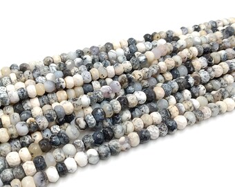 May include: A strand of white, gray, and black gemstone beads. The beads are round and have a speckled pattern.