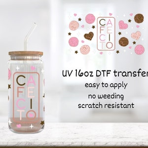 May include: A clear glass jar with a wooden lid and a straw. The jar has a pink and brown design with the word "CAFE CITO" on it. The jar is sitting on a white surface. UV 16oz DTF transfer, easy to apply, no weeding, scratch resistant.