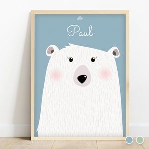 May include: A light blue background with a white polar bear illustration. The bear has pink cheeks and a black nose. The name "Paul" is written in white cursive above the bear.