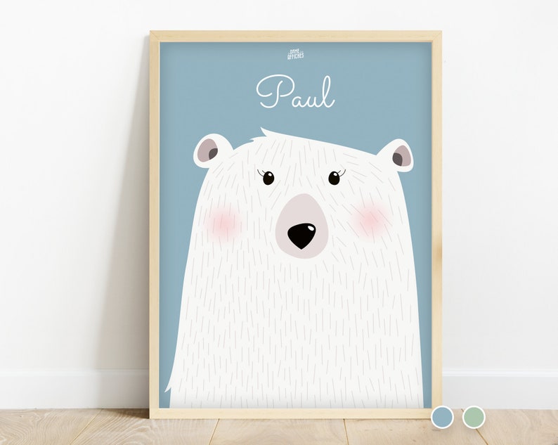 May include: A light blue background with a white polar bear illustration. The bear has pink cheeks and a black nose. The name "Paul" is written in white cursive above the bear.