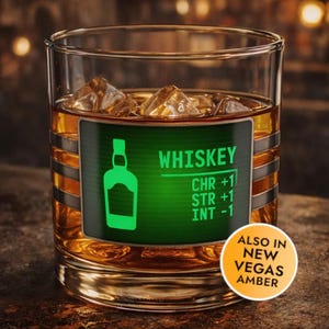 May include: A clear glass tumbler filled with amber liquid and ice cubes. A green rectangular label features a bottle icon, the text WHISKEY, and stats: CHR +1, STR +1, INT -1. A circular orange sticker reads ALSO IN NEW VEGAS AMBER.