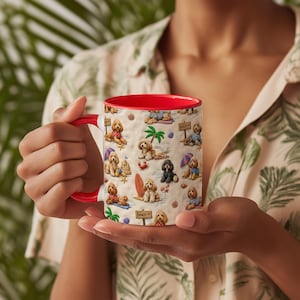 May include: A ceramic mug with a bright red interior and handle, featuring a repeating pattern of various doodle-type dogs on a sandy-coloured background. The illustrations depict dogs in beach attire, palm trees, surfboards, and beach signs.