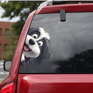 May include: A black and white cartoon dog peeking out of a car window. The dog has a big smile and is looking directly at the viewer.