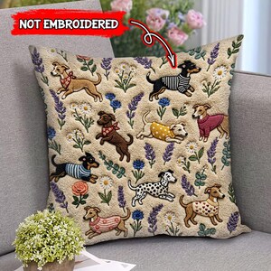 May include: Beige square throw pillow with a repeating pattern of running dogs wearing sweaters and bandanas, surrounded by flowers and foliage. The text "NOT EMBROIDERED" is in the upper left corner.