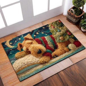 May include: A rectangular doormat depicting a sleeping dog in a striped sweater, resting on a pillow beneath a Christmas tree. The mat has a starry night sky background with a crescent moon and stars. The dog is brown and the sweater is red and green.