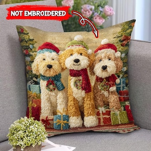 May include: A decorative square pillow featuring three cartoon dogs dressed in Christmas attire. The dogs wear Santa hats, scarves, and sweaters, surrounded by wrapped gifts. The pillow has a textured appearance with the words "NOT EMBROIDERED" in the upper left corner.