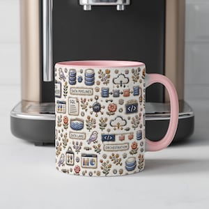 May include: A ceramic mug with a light pink handle and interior, featuring a repeating pattern of data engineering icons including SQL, data pipelines, data lake, orchestration, cloud symbols, code brackets, and small floral and bird illustrations.