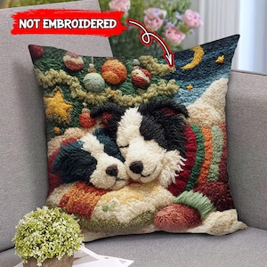 May include: A decorative pillow featuring two sleeping dogs, one with black and white fur and the other with black and teal fur. The pillow has a Christmas theme with ornaments, a star, and a night sky with a moon and stars. The text "NOT EMBROIDERED" is visible.