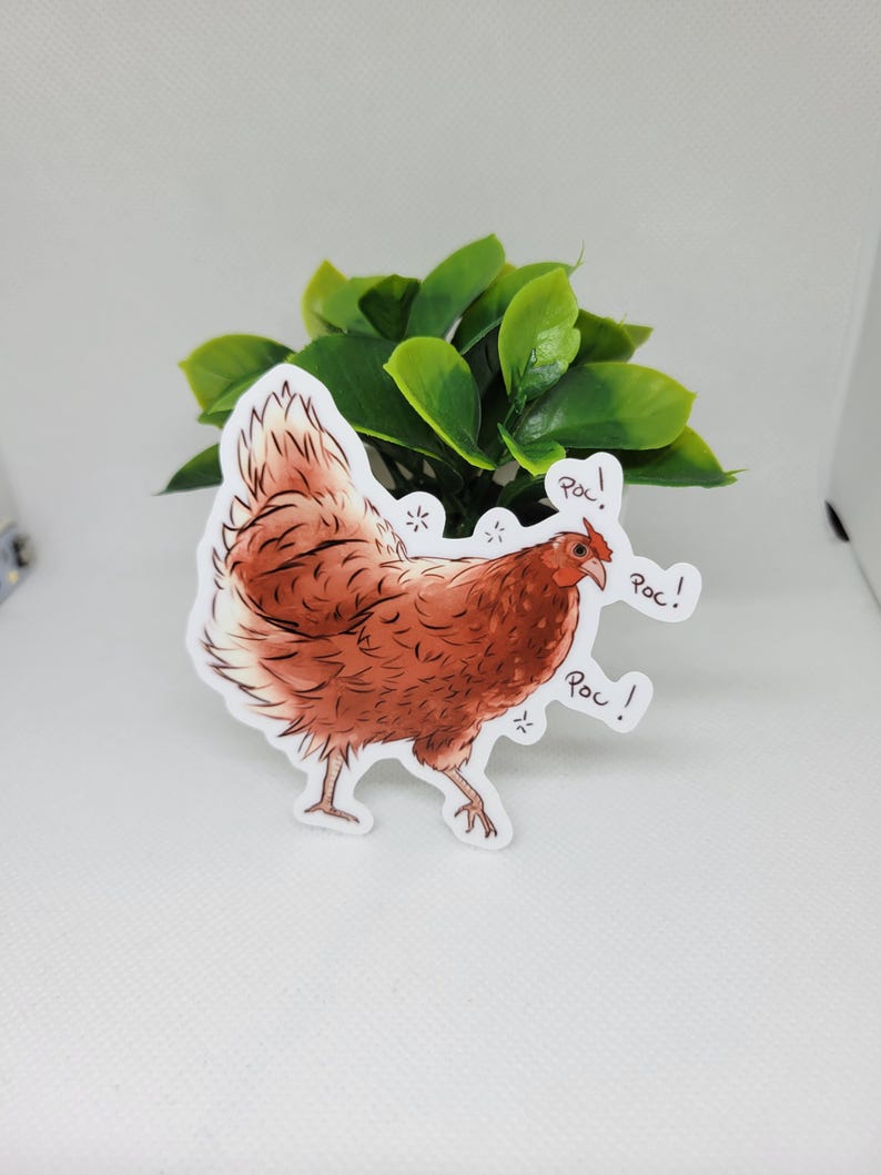 May include: A brown and white chicken sticker with the word "Roc!" written three times. The sticker is on a white background.