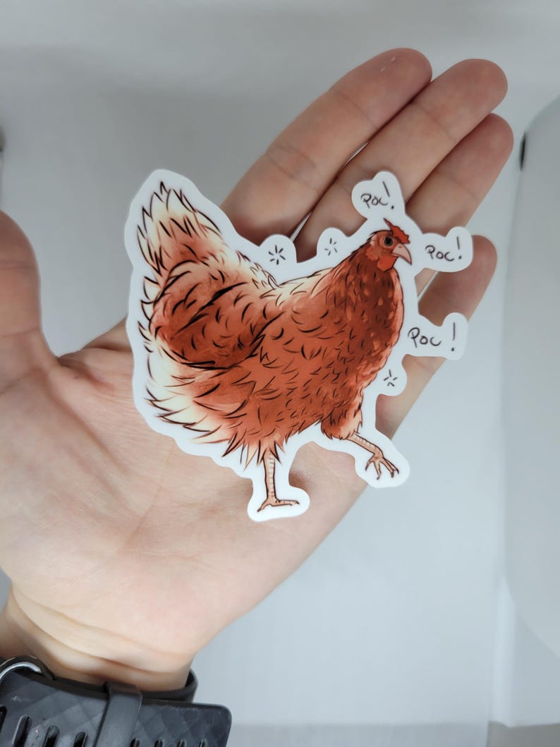 May include: A brown and white chicken sticker with the word "ROC!" written three times around it.