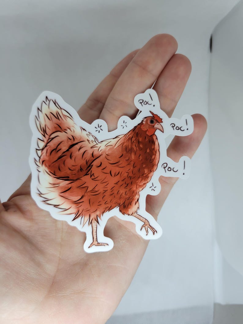 May include: A sticker of a brown chicken with a white chest and a red comb. The chicken is walking and has three speech bubbles that say "Roc!" in black text.