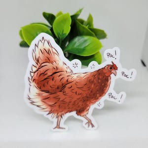 May include: A sticker of a brown chicken with a red comb and wattle. The chicken is walking and has three speech bubbles that say "Poc!" in black text.