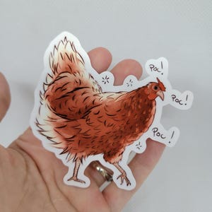 May include: A brown chicken sticker with the word "Poc!" written three times around it.