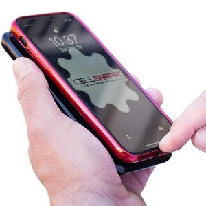 May include: A red phone case with a black phone inside. The phone case has a raised edge around the screen and a logo that says "CELL SNAPPIT - The Dust Welders of Choice".