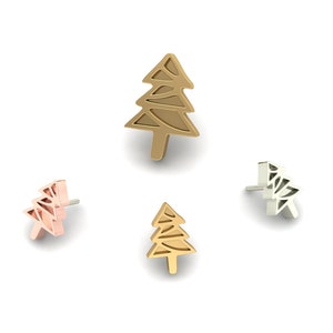 May include: Four tree-shaped stud earrings in gold, rose gold, and silver tones are arranged on a white background. The earrings have a minimalist, geometric design, with a post backing.