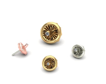 May include: Three pairs of earrings with a small diamond in the center of each. The earrings are in gold, silver, and rose gold.