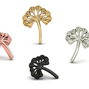 May include: Four nose studs in various metallic finishes: rose gold, gold, silver, and black. Each stud features a stylised, openwork leaf design. The leaves are clustered at the top, with a curved post for insertion.