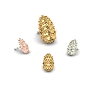 May include: Four decorative pine cone shaped drawer pulls in gold, silver, and rose gold.