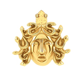 May include: A gold pendant featuring a detailed depiction of Medusa's head with snakes for hair. The pendant is a classic Greek mythology design.