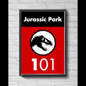 May include: Framed poster featuring the Jurassic Park logo. The top section is black with the words "Jurassic Park" in white. Below is a red section with a white circle containing a black dinosaur silhouette. The number "101" is in white.
