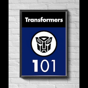 May include: A black framed poster with a blue background and the text "Transformers" in white at the top. A white circle with a black Transformers logo is in the center. The number "101" is in white at the bottom.
