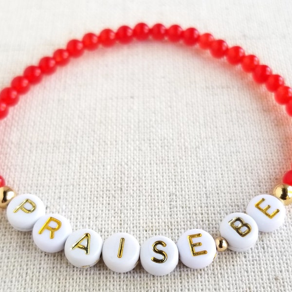 Handmaid's Tale "Praise Be" Stretch Bracelet | 4mm Red Chalcedony & Gold Hematite Gemstones, White and Gold Letter Beads | June Osborne