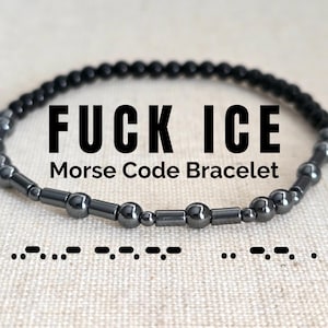 May include: Black beaded Morse code bracelet with the text "FUCK ICE". The bracelet is made of small, dark beads and features a series of dots and dashes representing the message in Morse code. The words "Morse Code Bracelet" are also visible.