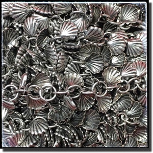 May include: A silver chain with a repeating pattern of small, detailed, scallop-shaped charms. The chain is made of metal and has a shiny finish.