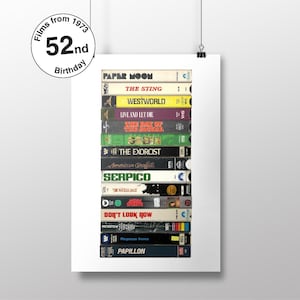 May include: A stack of VHS tapes featuring film titles from 1973, including "Paper Moon", "The Sting", "Westworld", "Live and Let Die", "The Day of the Jackal", "The Exorcist", "American Graffiti", "Serpico", "The Wicker Man", "Don't Look Now", "Papillon", and "Magnum Force".