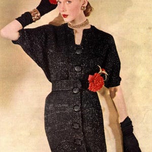 May include: A vintage fashion image featuring a woman in a black dress with a button-down front and a matching belt. She wears a red hat, black gloves, and a gold necklace. A red flower adorns the dress. The overall style is reminiscent of the mid-20th century.