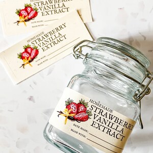 May include: A glass jar with a metal clasp lid and a label that reads "Homemade Strawberry Vanilla Extract". The label has a drawing of strawberries and vanilla beans. The label also has the text "Date Made:" and "Made With:".