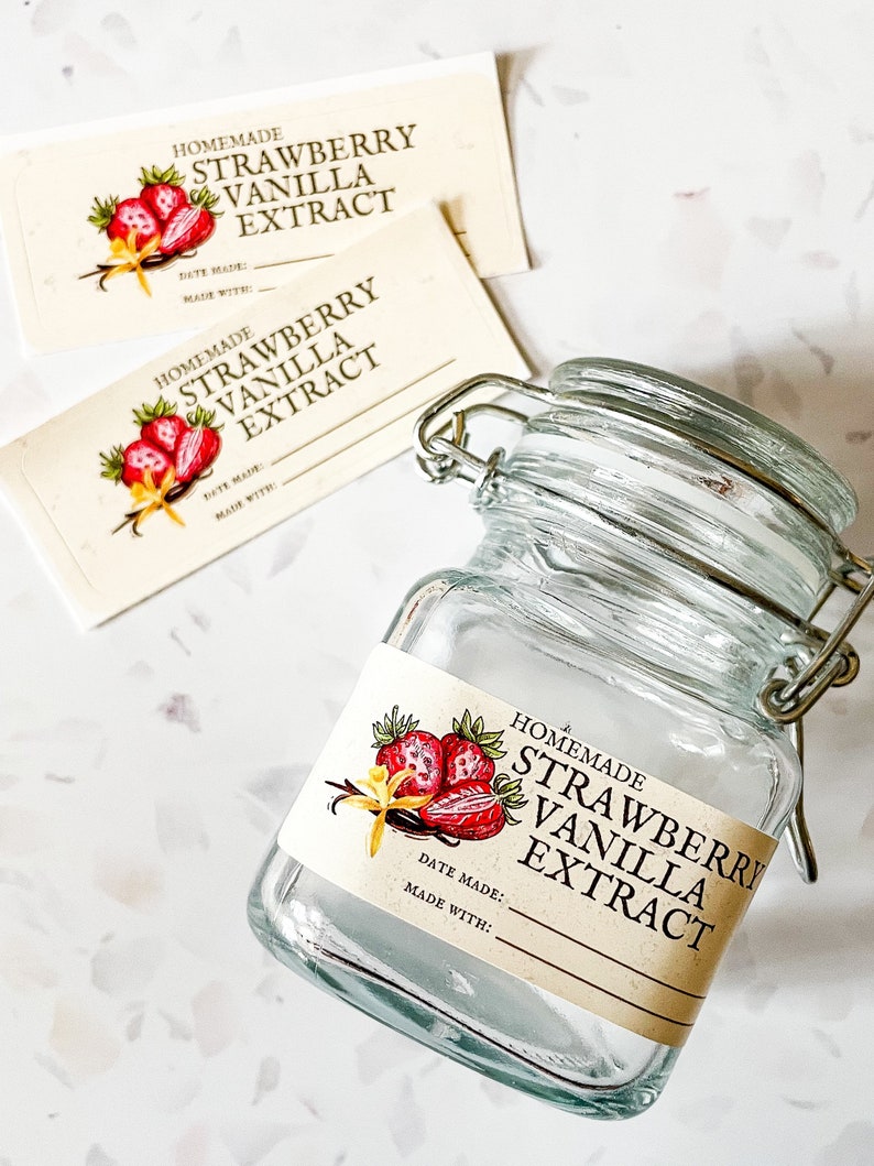 May include: A glass jar with a metal clasp lid and a label that reads "Homemade Strawberry Vanilla Extract". The label has a drawing of strawberries and vanilla beans. The label also has the text "Date Made:" and "Made With:".