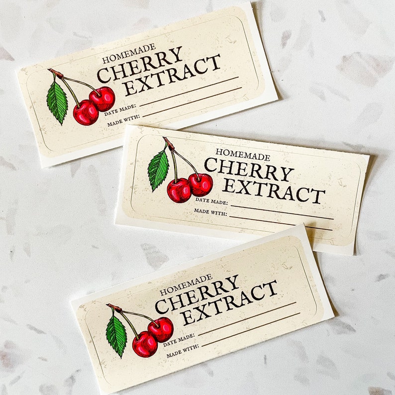 May include: Three blank labels for homemade cherry extract. Each label features a hand-drawn illustration of a cherry branch with two red cherries. The labels have the text "HOMEMADE CHERRY EXTRACT" and spaces for the date made and ingredients.