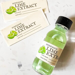 May include: Three labels for homemade lime extract. The labels are cream colored with brown text and a green lime illustration. The labels have space to write the date made and what the extract was made with. A clear glass bottle with a black lid filled with green liquid is labeled "Homemade Lime Extra".