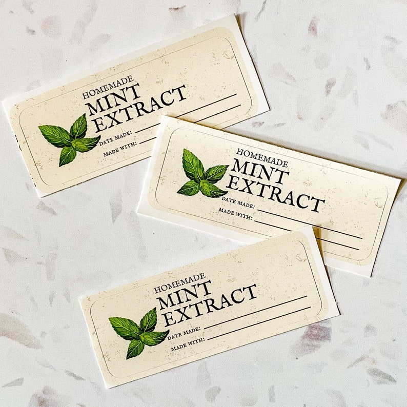 May include: Three cream-colored labels with a green mint leaf design. The labels read "Homemade Mint Extract" with lines for writing the date made and ingredients used.