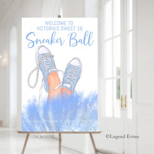 May include: A blue and white welcome sign for a Sweet 16 party with the text "Welcome to Victoria's Sweet 16 Sneaker Ball". The sign features a pair of blue sneakers with white laces and a pearl necklace.