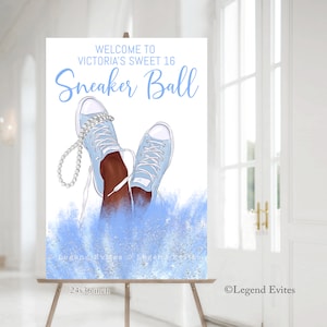 May include: A blue and white welcome sign for a Sweet 16 party with the text "Welcome to Victoria's Sweet 16 Sneaker Ball". The sign features a pair of blue sneakers with white laces and a pearl necklace. The background is a light blue and silver glitter effect. The sign is 24 inches by 36 inches.