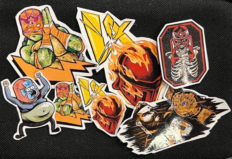 May include: A set of eight colorful stickers featuring wrestlers in various poses. The stickers are on a black background. The stickers are all different sizes and shapes. Some of the stickers have a lightning bolt design. One sticker features a wrestler with a skeleton inside.