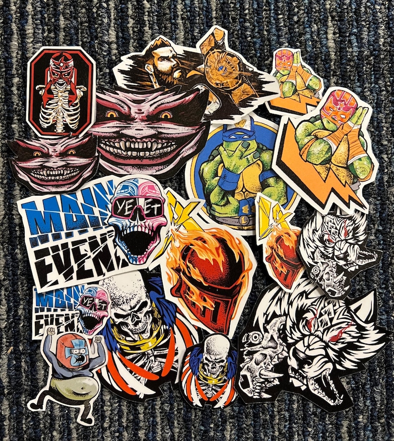 May include: A collection of colorful stickers featuring various characters and designs. Some of the stickers include a skull with sunglasses, a wrestler, a ninja turtle, and a wolf. The stickers are on a brown carpet.